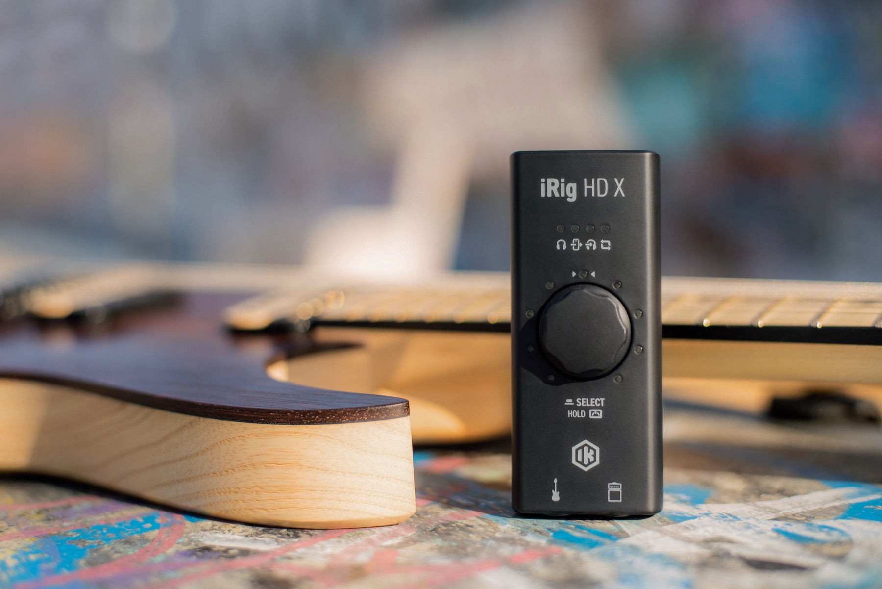 An iRig HD X beside a guitar